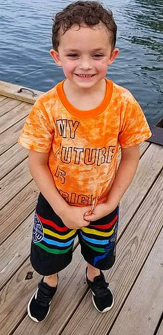 Kolby is registered to the contest to win money with this photo: active_pants, cool, green, hair, hairstyle, happy, head, joy, muscle, neck, orange, person, photograph, sleeve, smile, standing, t_shirt, thigh, waist, water