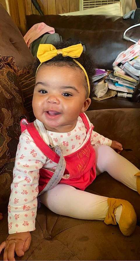 Ariyan is registered to the contest to win money with this photo: black_hair, cheek, child, ear, eye, eyelash, face, fashion_accessory, fun, happy, human_body, jewellery, neck, person, room, sitting, skin, thigh, toddler, tradition