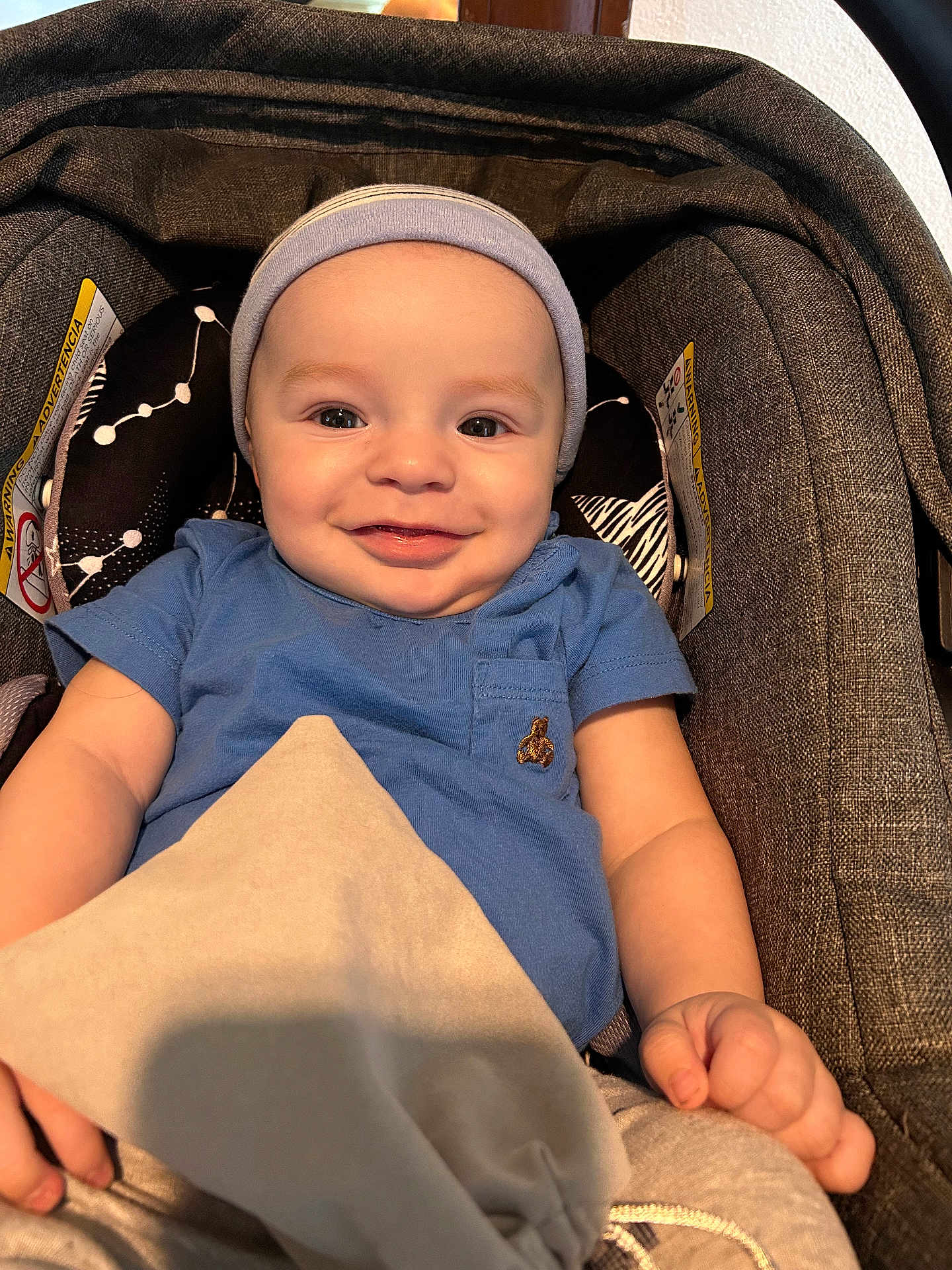 Samuel Castro joined the competition — help win amazing prizes! baby, infant, smile, blue_shirt, headband, blanket, car_seat, child, happy, cute, portrait, seated, indoors, person, clothing, fabric, hand, face, skin, comfort