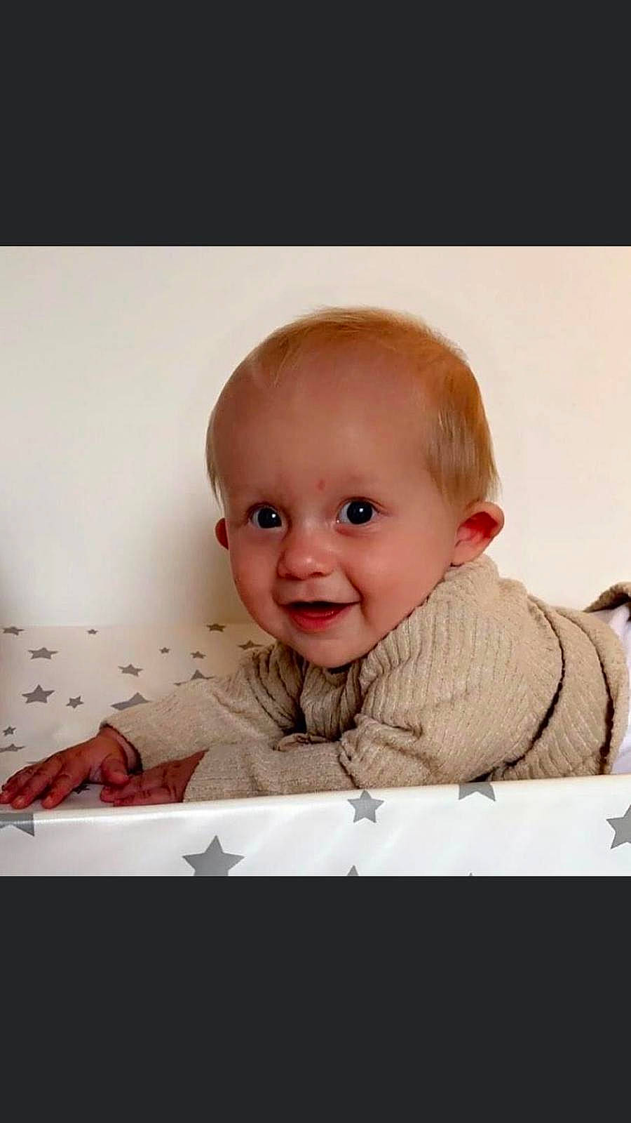 Lottie is registered to the contest to win money with this photo: art, baby, baby_toddler_clothing, cheek, child, comfort, eyebrow, eyelash, flash_photography, happy, iris, mouth, nose, person, photo_caption, rectangle, sitting, sleeve, smile, toddler