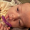 Isabel is registered to the contest to win money with this photo: baby, pacifier, close_up, blanket, sleepy, infant, hand, face, skin, resting, cozy, soft, comfort, child, young, indoors, portrait, cute, newborn, toddler
