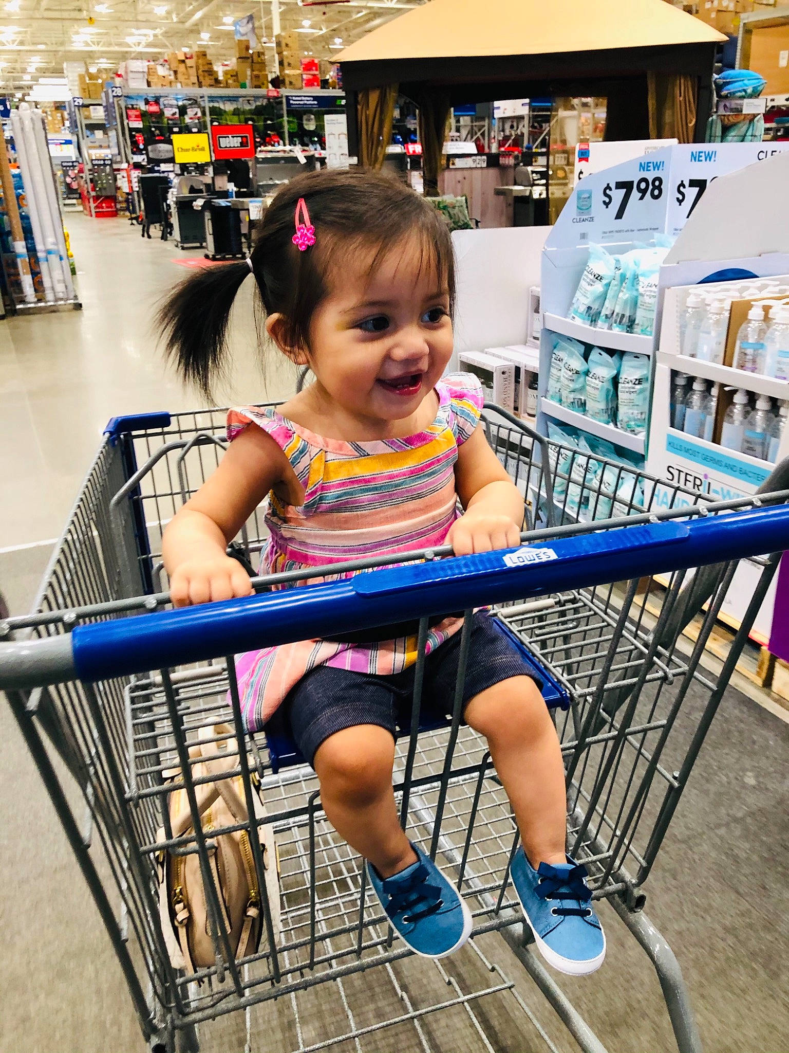 Aliyanna is registered to the contest to win money with this photo: cart, child, clothing, customer, fun, joy, leg, leisure, person, retail, shelf, shopping, shopping_cart, shorts, skin, smile, standing, summer, thigh, tire