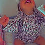 Leewena a rejoint le concours — aidez-le/la à gagner de superbes lots ! child, toddler, laughing, smiling, sitting, floral_outfit, headband, bed, pillow, star_pattern, face, hands, legs, bottle, basket, nursery_room, indoor, portrait, candid, cute