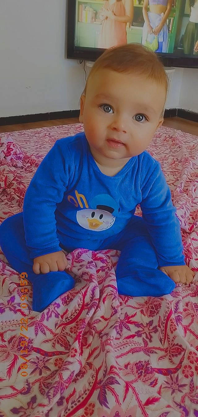 François participe au concours pour gagner de l'argent avec cette photo : baby, baby_toddler_clothing, cheek, child, electric_blue, flooring, head, iris, linens, mouth, outerwear, pajamas, pattern, person, product, sitting, skin, sleeve, t_shirt, toddler