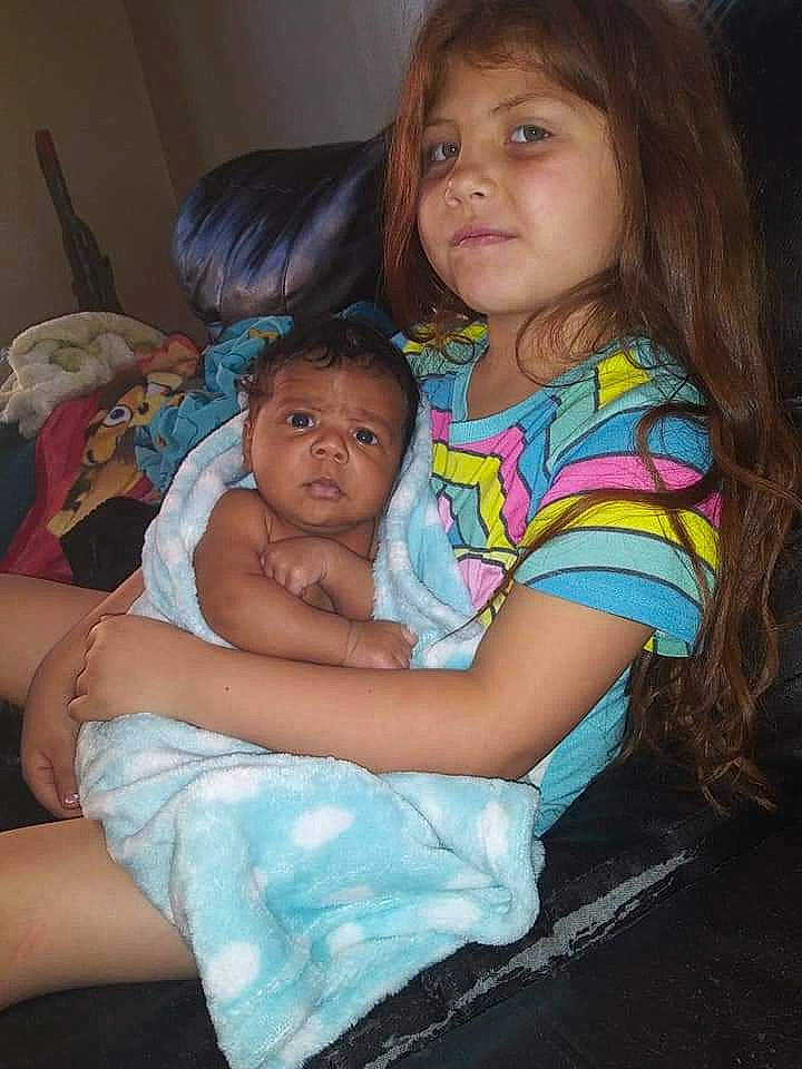 Aisha is registered to the contest to win money with this photo: baby, cheek, child, eye, fun, hug, iris, lap, person, sitting, skin, smile, toddler