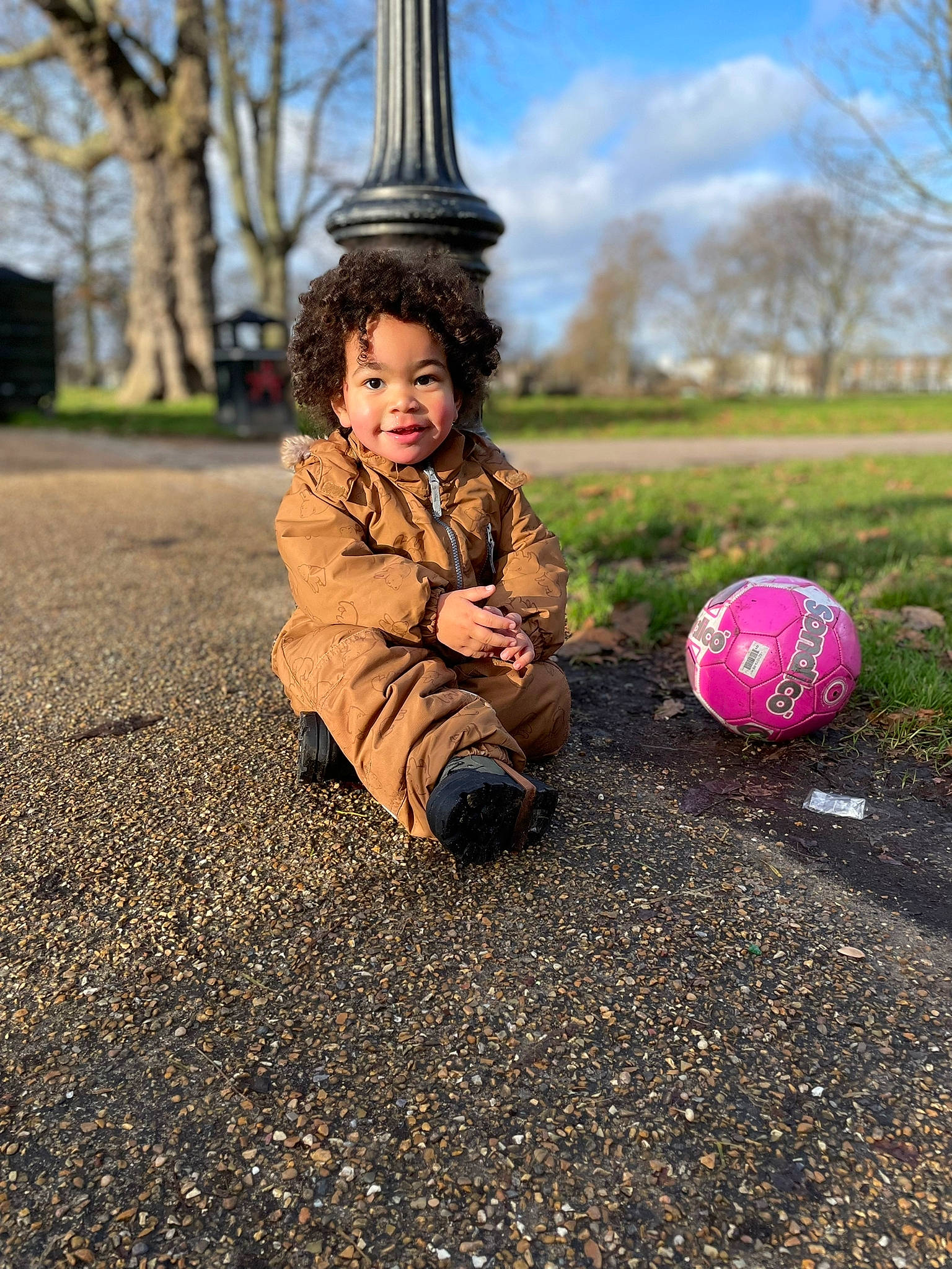 Ezra is registered to the contest to win money with this photo: asphalt, ball, beauty, flooring, fun, grass, happy, jacket, joy, leaf, morning, people_in_nature, person, plant, public_space, road_surface, sky, standing, sunlight, tints_and_shades