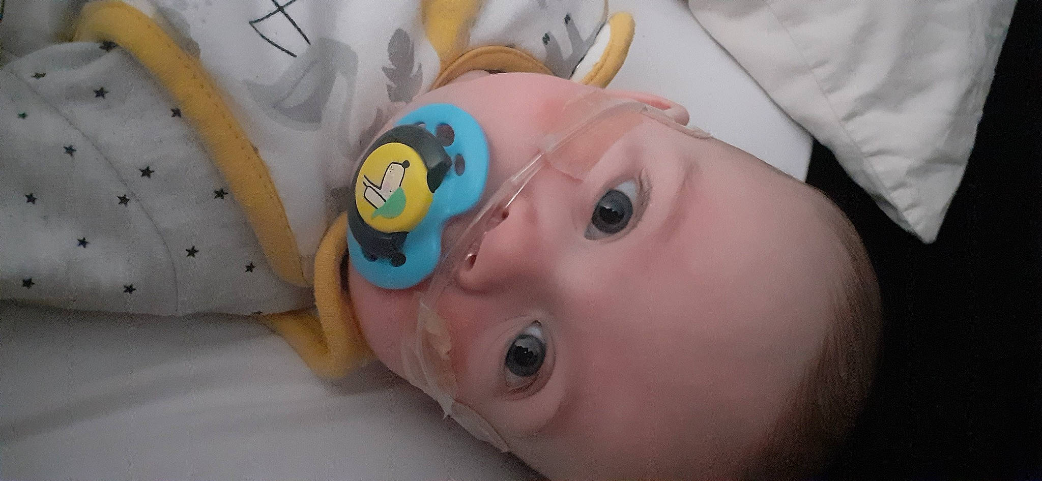 Ernie is registered to the contest to win money with this photo: baby, baby_products, baby_toddler_clothing, cheek, child, ear, eyelash, fun, happy, hat, headgear, iris, leisure, linens, mouth, neck, nose, person, skin, toddler