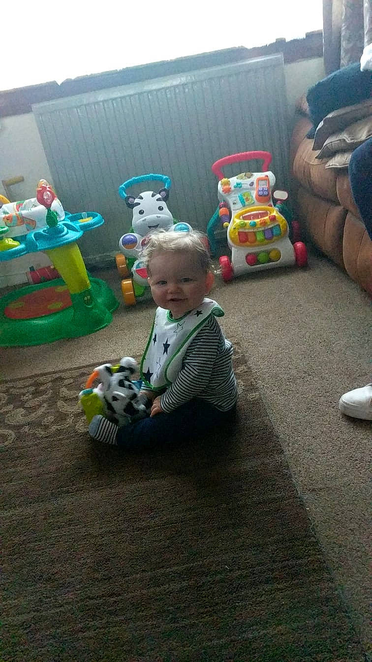 Fletcher joined the competition — help win amazing prizes! baby, child, floor, flooring, fun, person, play, room, sitting, toddler, toy