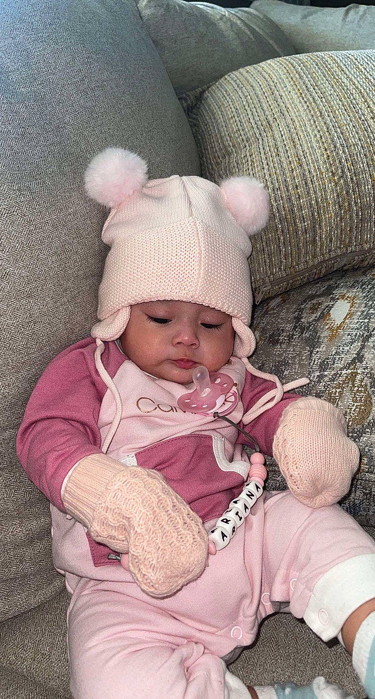 Ariana joined the competition — help win amazing prizes! baby, baby_sleeping, baby_toddler_clothing, cap, cheek, comfort, cool, head, headwear, knit_cap, linens, nose, person, pink, skin, sleeve, textile, toddler, white, wood