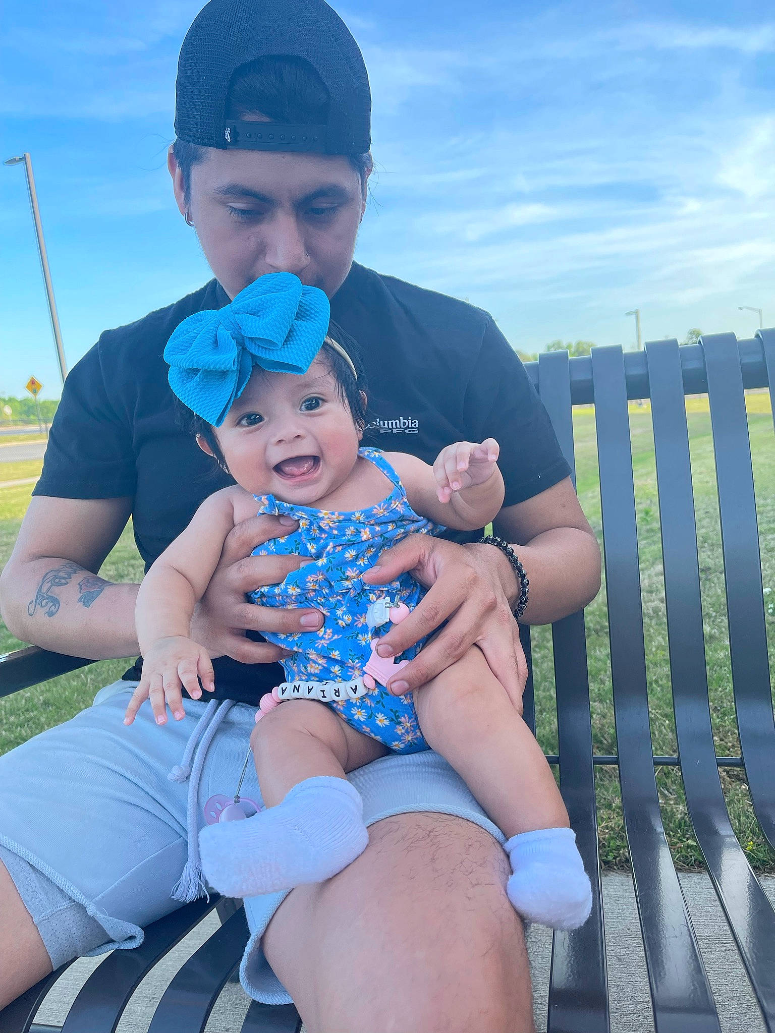 Ariana is registered to the contest to win money with this photo: azure, baby, baby_toddler_clothing, blue, child, cloud, electric_blue, face, finger, fun, grass, happy, hat, headwear, human_leg, lap, leisure, person, recreation, sky