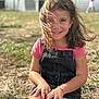 Layana participe au concours pour gagner de l'argent avec cette photo : child, girl, smile, outdoor, grass, sunlight, hair, happy, casual_clothing, pink_shirt, black_overall, bracelet, nature, portrait, sitting, daylight, person, background_blur, playful, young