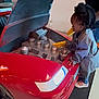 Riley joined the competition — help win amazing prizes! activity, car_engine, child, curious, floor, footwear, hairstyle, hand, imaginative_play, indoor, mat, mechanic_outfit, person, play, pretend, red, side_view, toy_car, yellow_tool, young_child