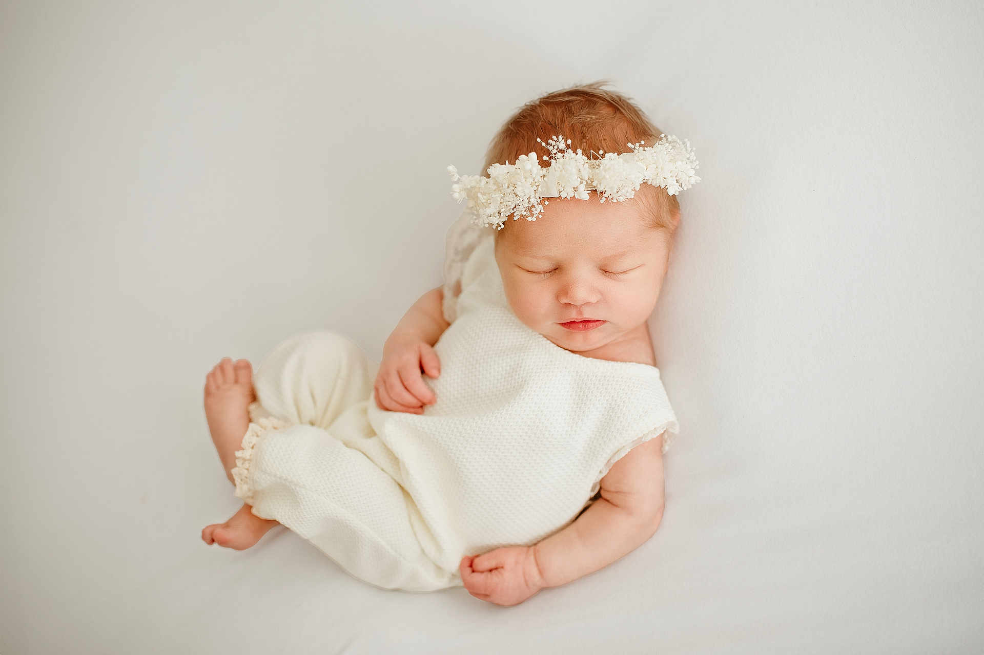Evangeline is registered to the contest to win money with this photo: newborn, baby, sleeping, white_outfit, floral_headband, soft, peaceful, infant, cute, portrait, child, resting, skin, hand, foot, closed_eyes, adorable, cozy, lying_down, minimalist_background