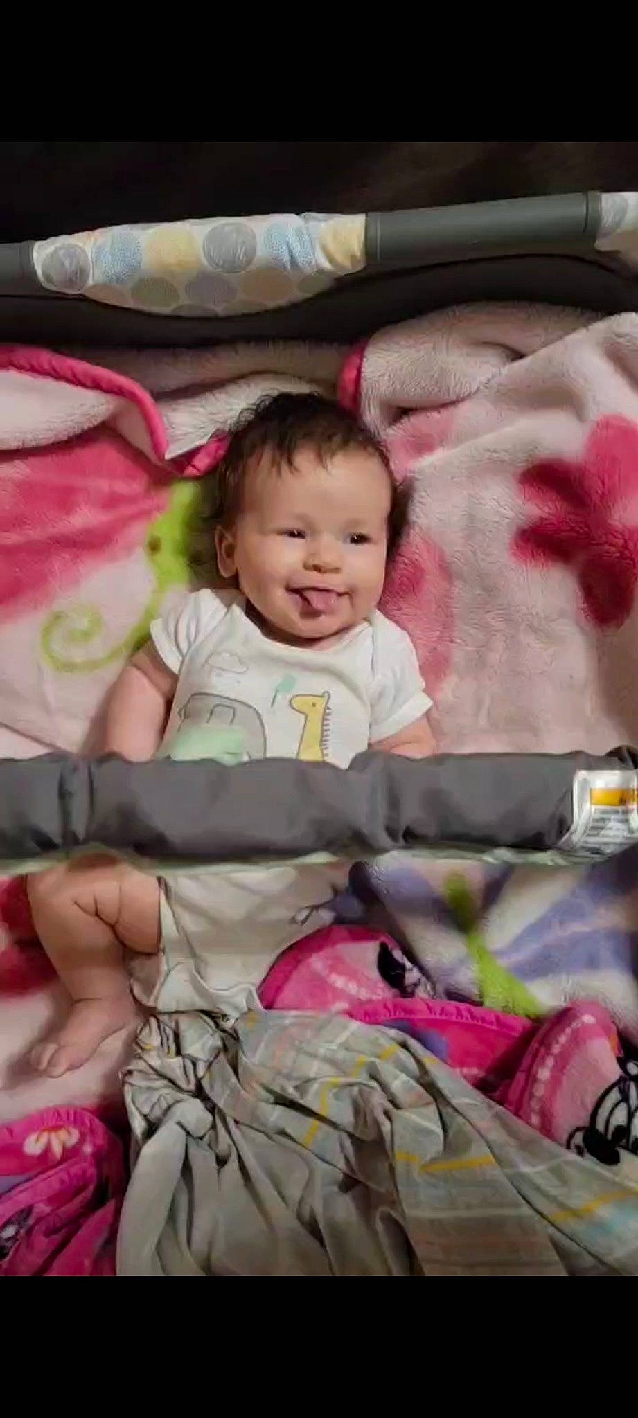 Jenna is registered to the contest to win money with this photo: baby, baby_products, baby_toddler_clothing, cheek, child, comfort, facial_expression, happy, joy, linens, magenta, pattern, people, person, pink, sitting, skin, sleeve, smile, t_shirt