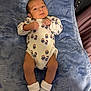 baby, infant, onesie, socks, blanket, blue_blanket, lying_down, indoors, cute, soft_texture, child, newborn, person, portrait, sleepwear, cozy, resting, young_child, comfortable, face