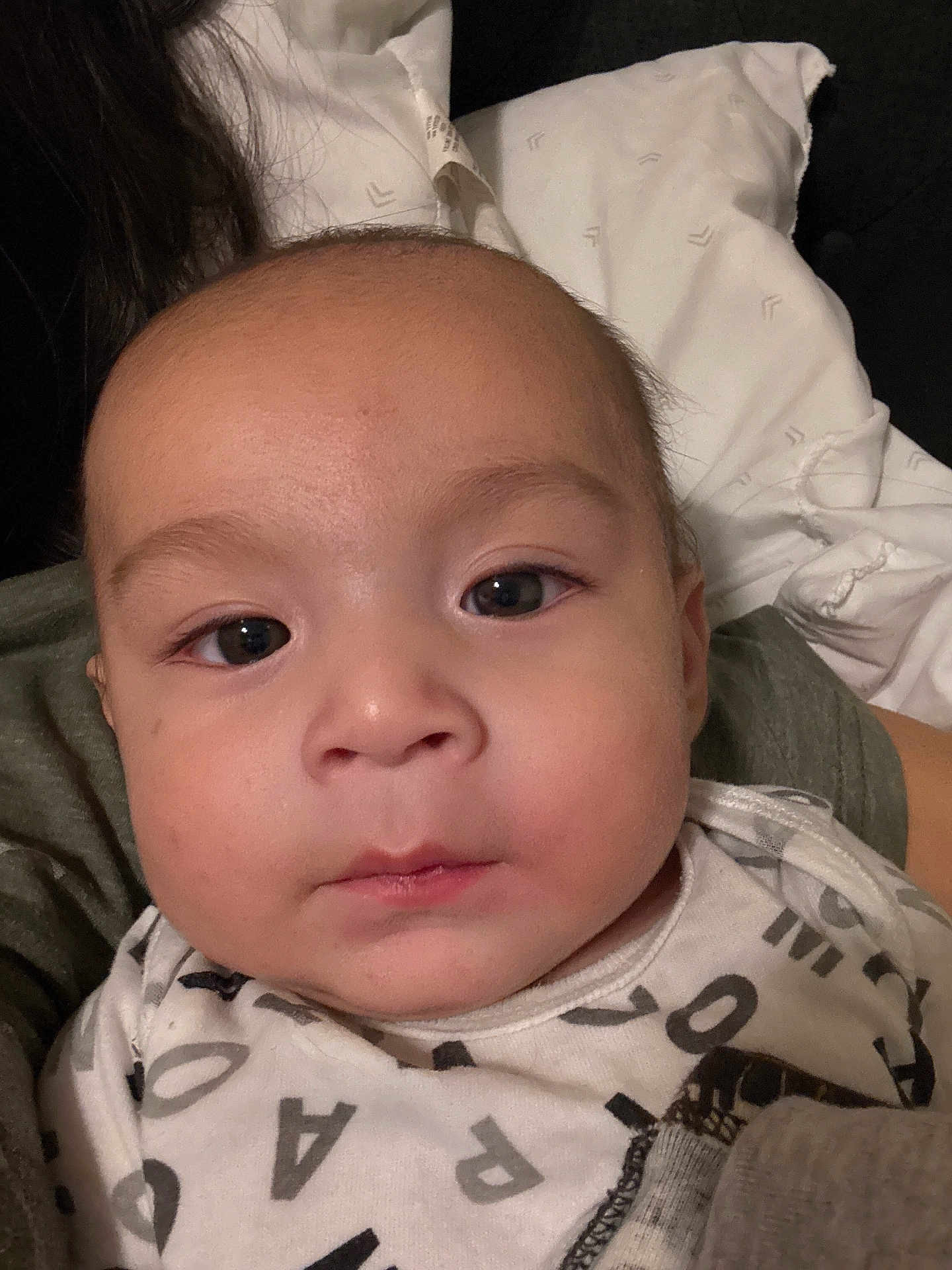 Noah joined the competition — help win amazing prizes! baby, face, infant, portrait, onesie, clothing, person, child, young, head, eyes, skin, expression, indoor, pillow, resting, human, closeup, cute, youngchild