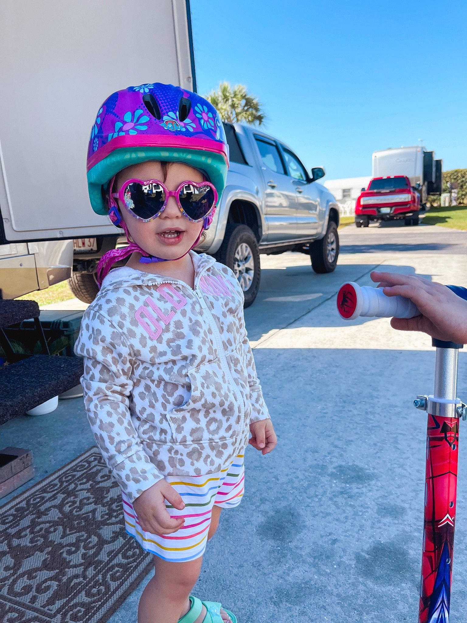 Emmy is registered to the contest to win money with this photo: car, eyewear, fun, glasses, goggles, hat, headgear, headwear, leisure, person, product, recreation, shoe, sky, sneakers, street_fashion, sunglasses, tire, toy, vehicle
