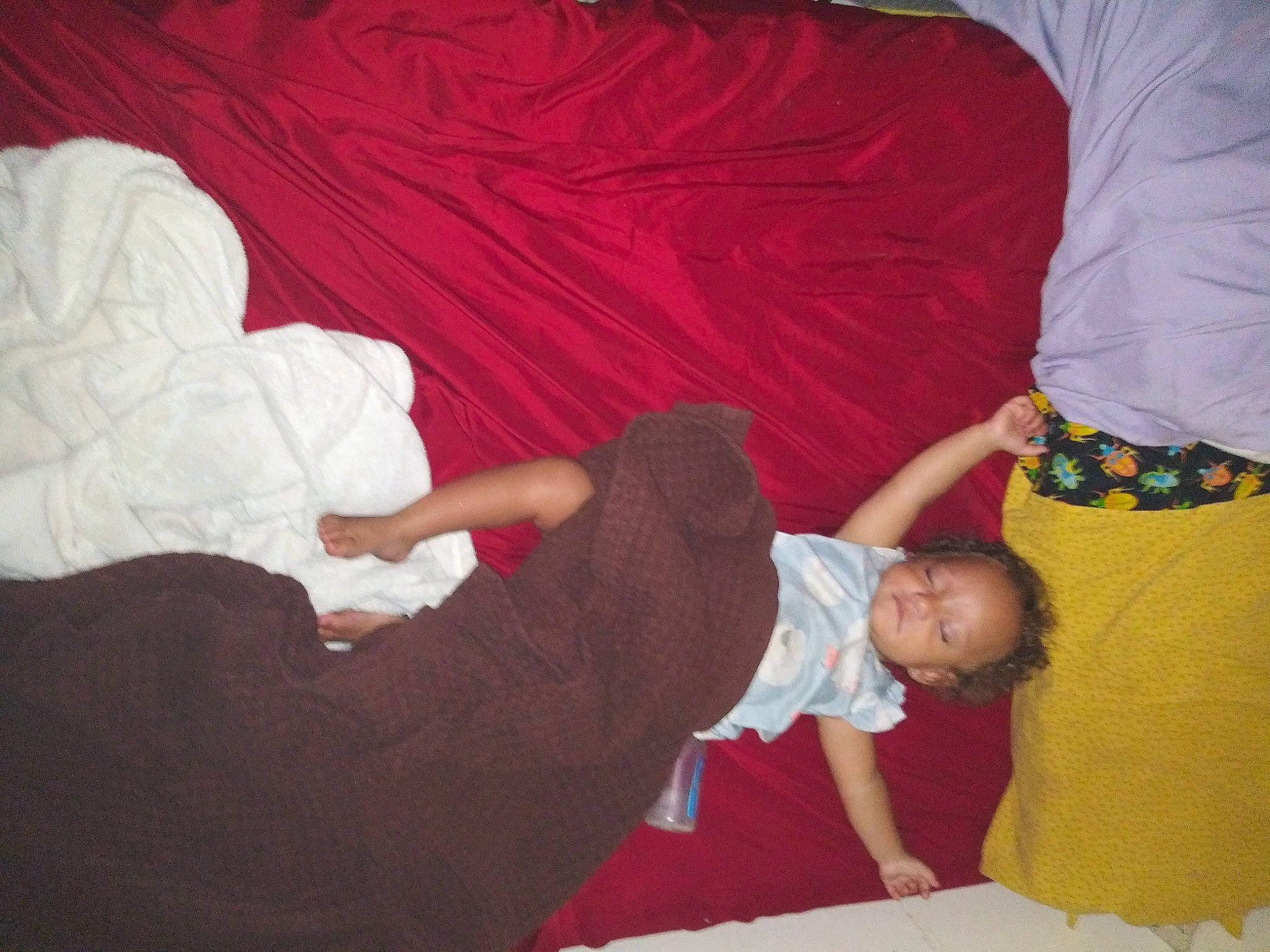 Ka'Mya is registered to the contest to win money with this photo: baby, baby_toddler_clothing, child, comfort, elbow, finger, flooring, fun, gesture, human_leg, interaction, lap, linens, person, red, room, sitting, thigh, thumb, toddler