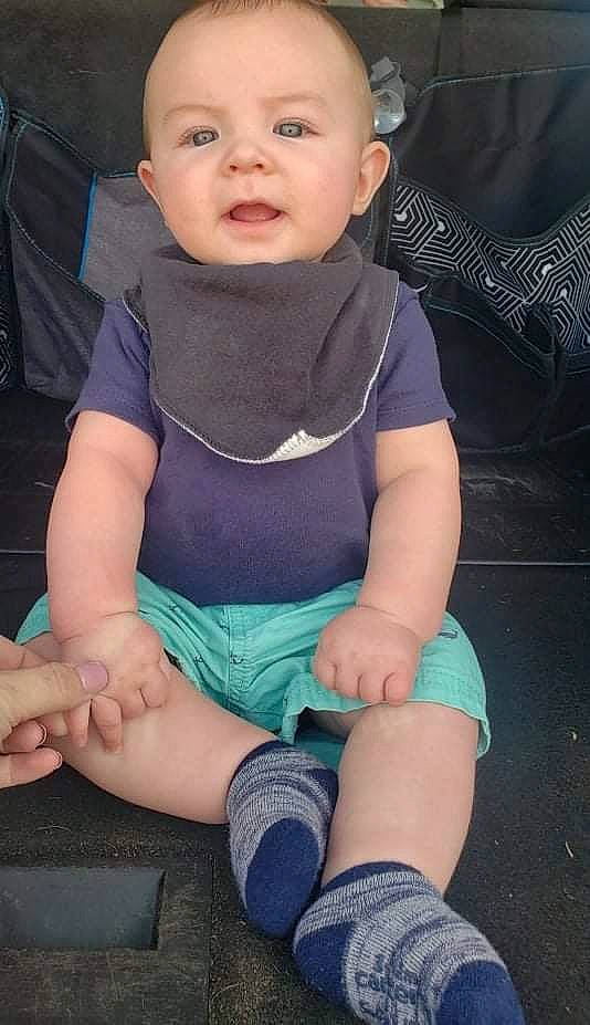 Brantlee is registered to the contest to win money with this photo: baby_toddler_clothing, black, cheek, chin, comfort, cool, face, finger, hand, head, human_body, joint, knee, lap, leg, neck, person, skin, sleeve, standing