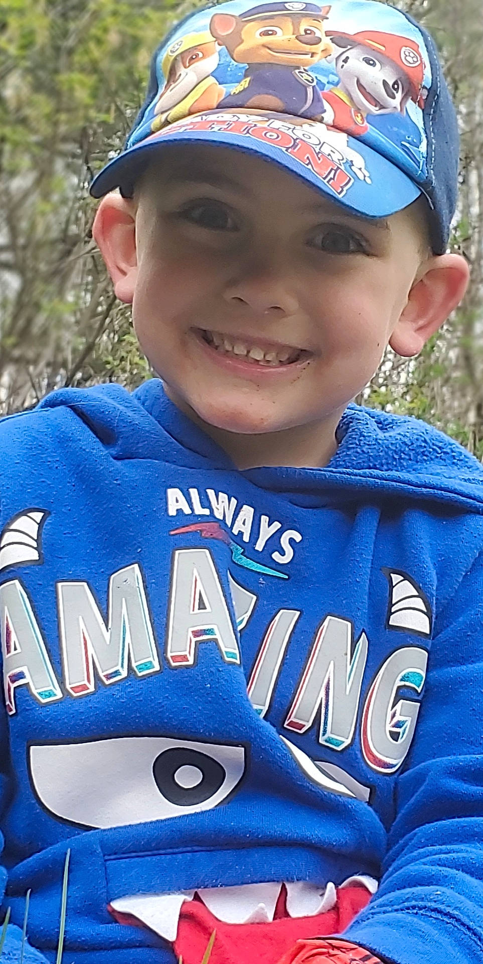 Kadyn is registered to the contest to win money with this photo: baseball_uniform, cap, child, cool, facial_expression, headwear, joy, person, sleeve, smile, sports_uniform, t_shirt