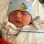 Bentley is registered to the contest to win money with this photo: newborn, baby, sleeping, hat, bear, embroidery, blanket, striped, cozy, soft, wrapped, face, headwear, infant, peaceful, indoors, cute, child, portrait, resting
