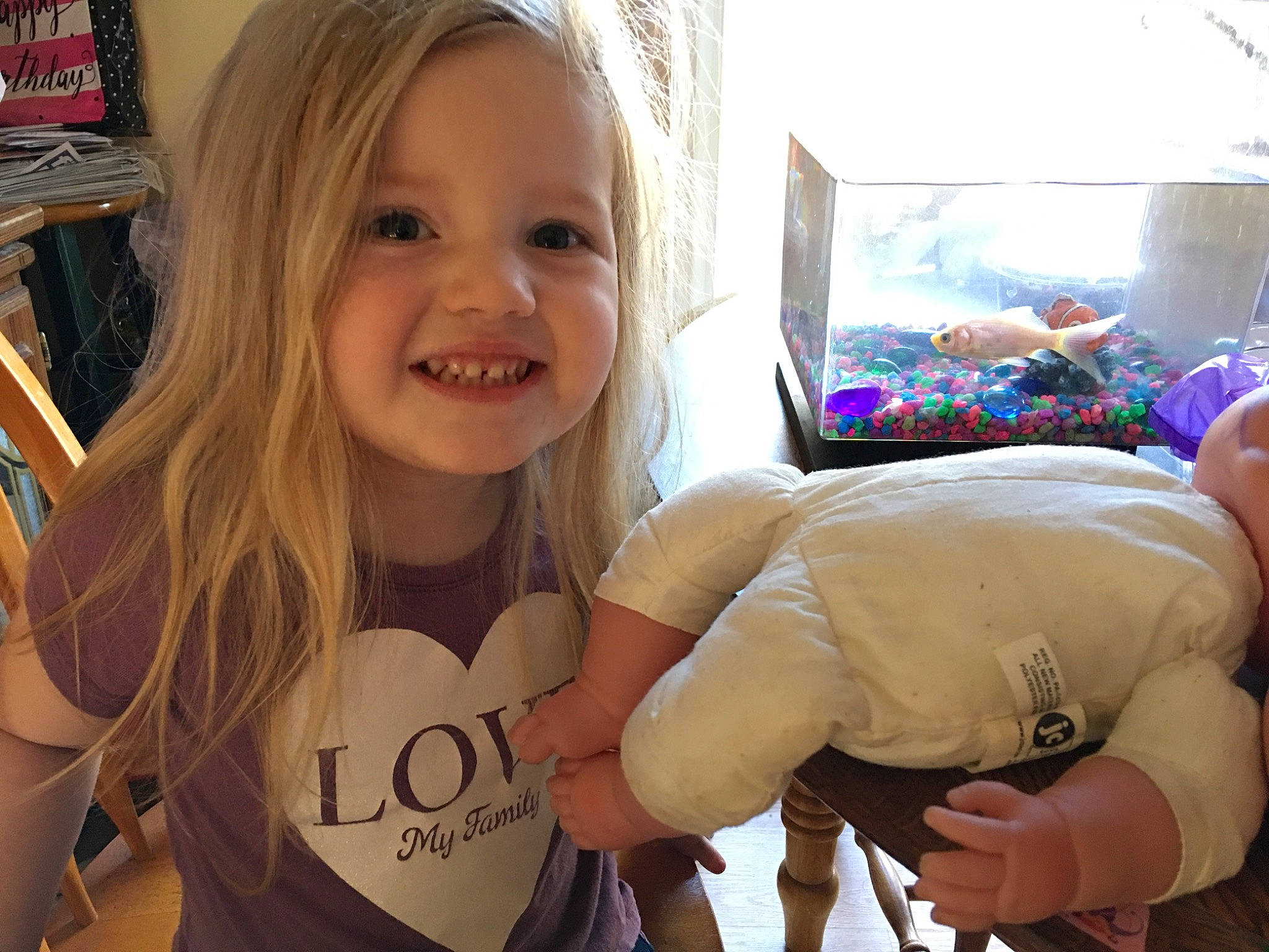 Sofia is registered to the contest to win money with this photo: arm, blond, cheek, child, ear, face, finger, fun, hand, happy, head, joy, laugh, long_hair, person, play, skin, smile, t_shirt, thumb