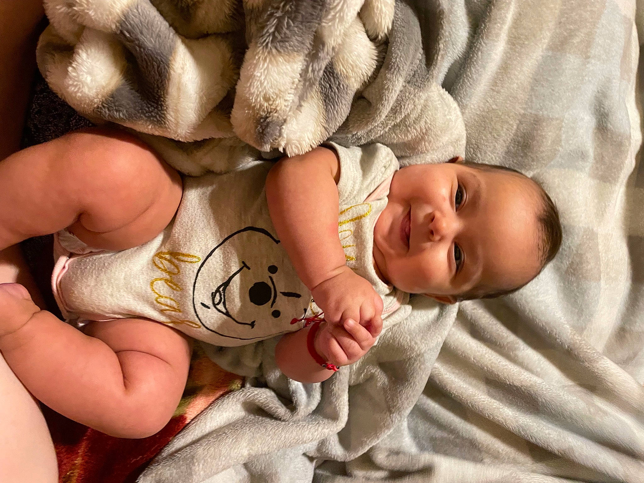 April Clementine is registered to the contest to win money with this photo: baby, baby_toddler_clothing, beauty, child, comfort, face, finger, football, gesture, hand, happy, headgear, human_leg, joy, linens, nail, person, skin, smile, toddler