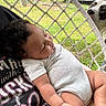 Kehlani joined the competition — help win amazing prizes! baby, sleeping, person, dog, hammock, netting, outdoor, grass, chainlink_fence, car, curious_dog, arms, clothing, toddler, relaxing, daylight, nature, portrait, resting, peaceful