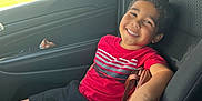 Kaison joined the competition — help win amazing prizes! child, boy, smiling, car, car_seat, red_shirt, black_shorts, seatbelt, window, daylight, happy, casual, portrait, interior, relaxed, young, person, vehicle, sunlight, seat