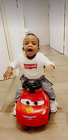 Liam a rejoint le concours — aidez-le/la à gagner de superbes lots ! baby_toddler_clothing, cheek, child, comfort, cool, finger, floor, flooring, fun, hand, person, plastic, product, red, riding_toy, sitting, skin, standing, toddler, toy