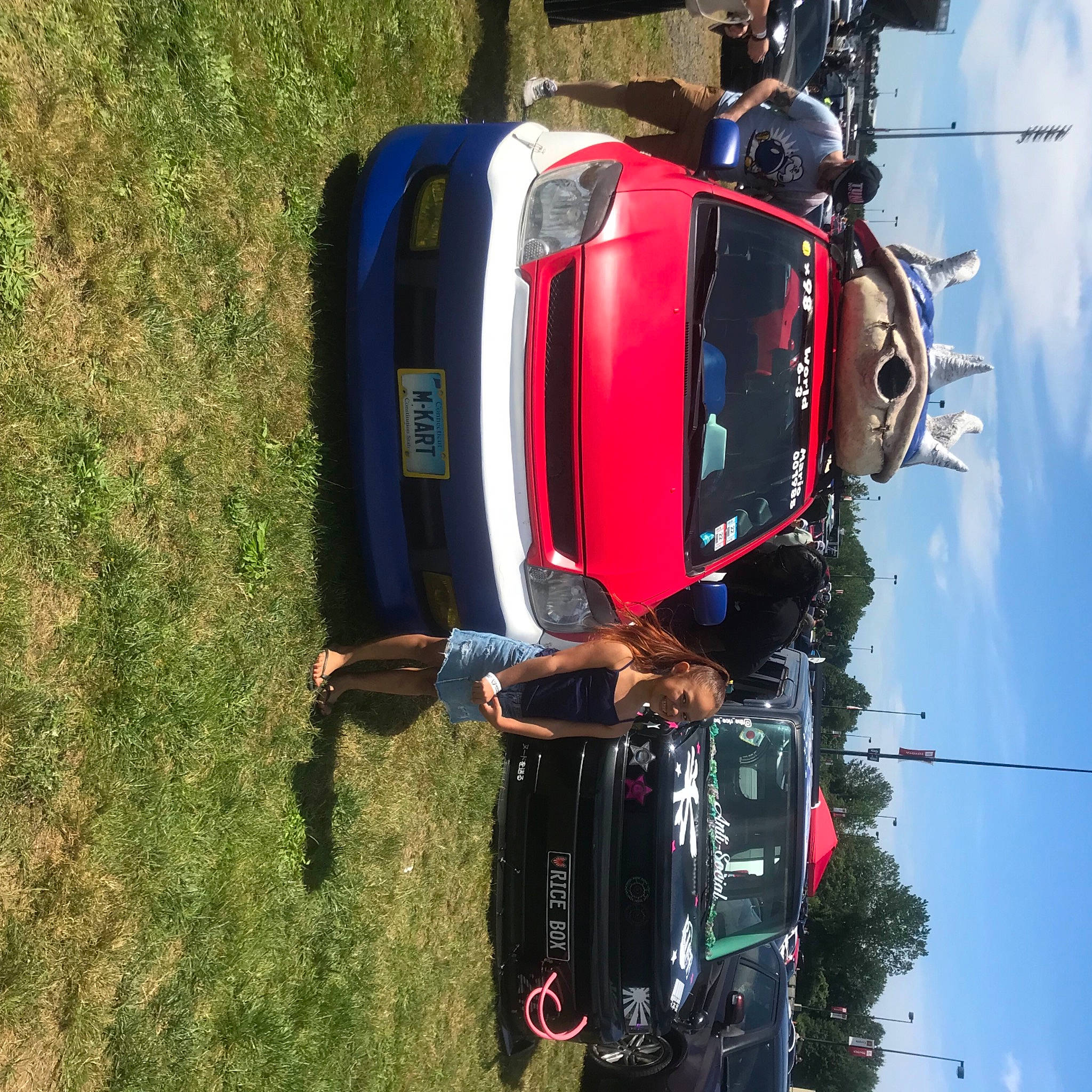 Jessenia joined the competition — help win amazing prizes! automotive_design, automotive_exterior, automotive_lighting, automotive_parking_light, automotive_side_view_mirror, automotive_tail_brake_light, automotive_tire, bumper, car, cloud, fender, hood, joy, kit_car, land_vehicle, motor_vehicle, person, sky, tire, tree