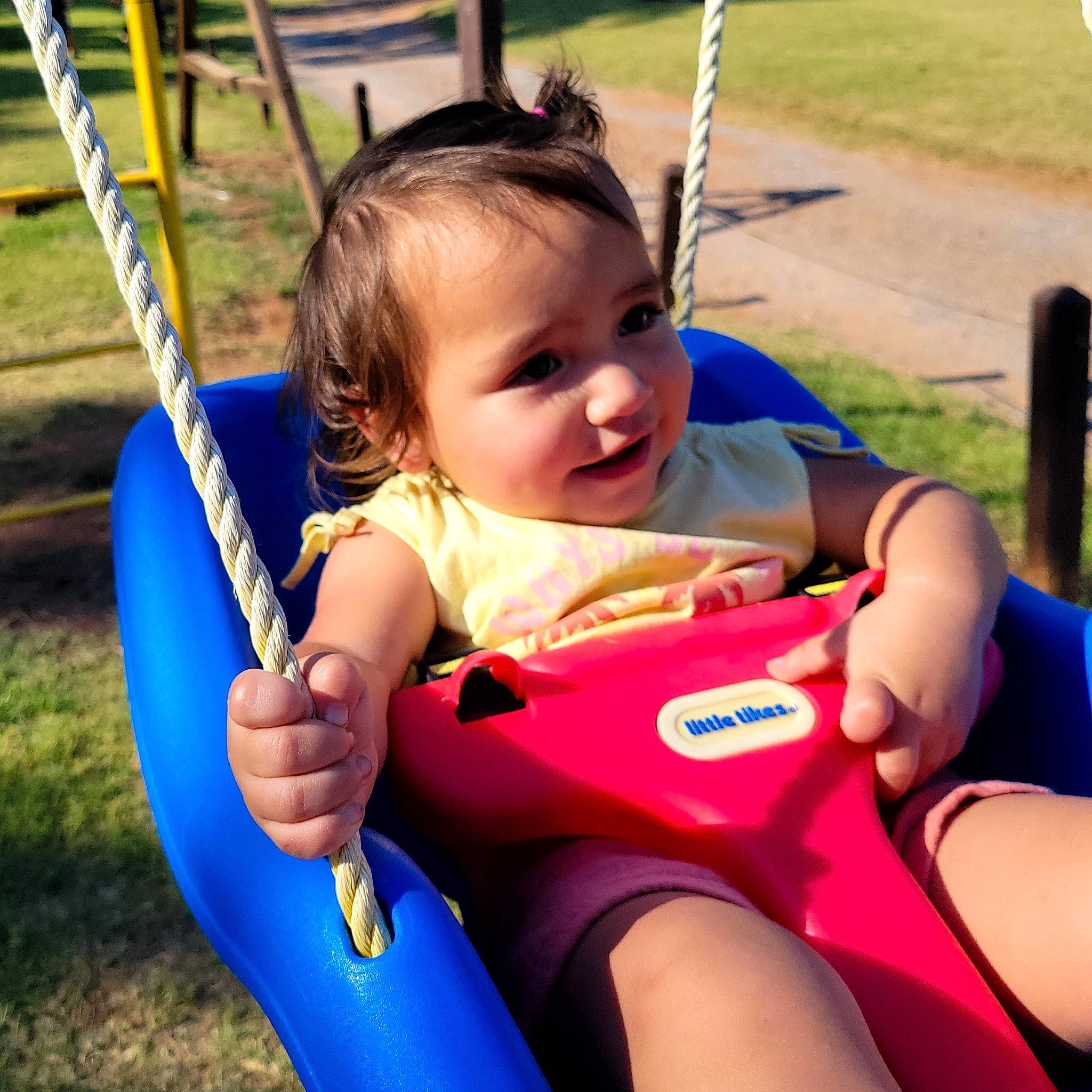 Clarissa is registered to the contest to win money with this photo: baby, baby_toddler_clothing, beauty, blue, child, city, facial_expression, fun, grass, happy, leisure, nature, person, plant, playground, product, recreation, skin, smile, swing