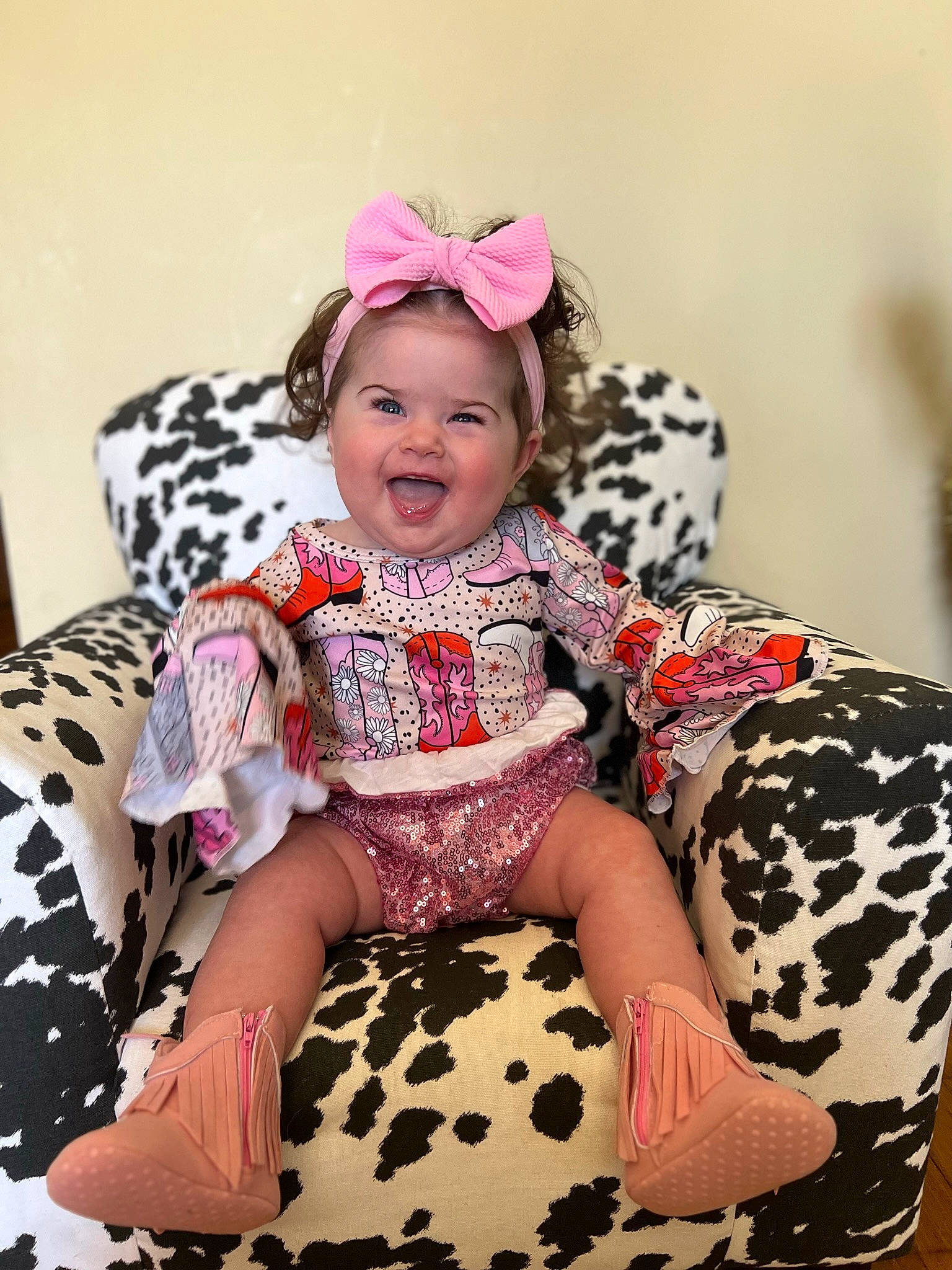 Hadley is registered to the contest to win money with this photo: baby, baby_toddler_clothing, child, costume, costume_hat, dress, embellishment, fashion_accessory, hairstyle, happy, headband, headpiece, magenta, pattern, person, pink, sitting, sleeve, smile, thigh
