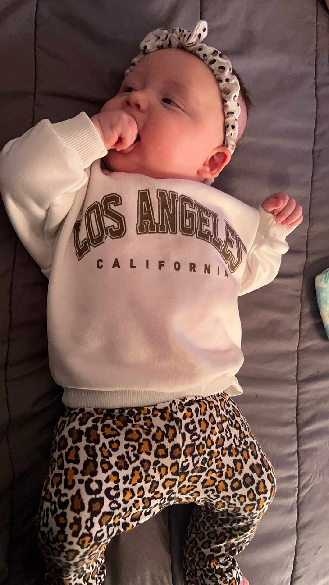 Raya joined the competition — help win amazing prizes! baby, bodypart, bonnet, cap, clothing, couch, cushion, face, finger, furniture, hand, hat, head, homedecor, newborn, pants, person, photography, portrait, shorts