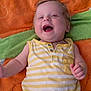 Maxime participe au concours pour gagner de l'argent avec cette photo : baby, child, smiling, laughing, yellow_striped_clothing, striped_onesie, blanket, orange_blanket, green_blanket, happy, infant, cute, lying_down, portrait, skin, face, hand, small_fingers, indoor, young_child