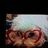 Tango a rejoint le concours — aidez-le/la à gagner de superbes lots ! accessory, animal, close_up, cute, dog, eyes, face, fluffy, funny, furry, glasses, heart_shaped, indoor, lying_down, nose, pet, portrait, red, screen_photo, whiskers