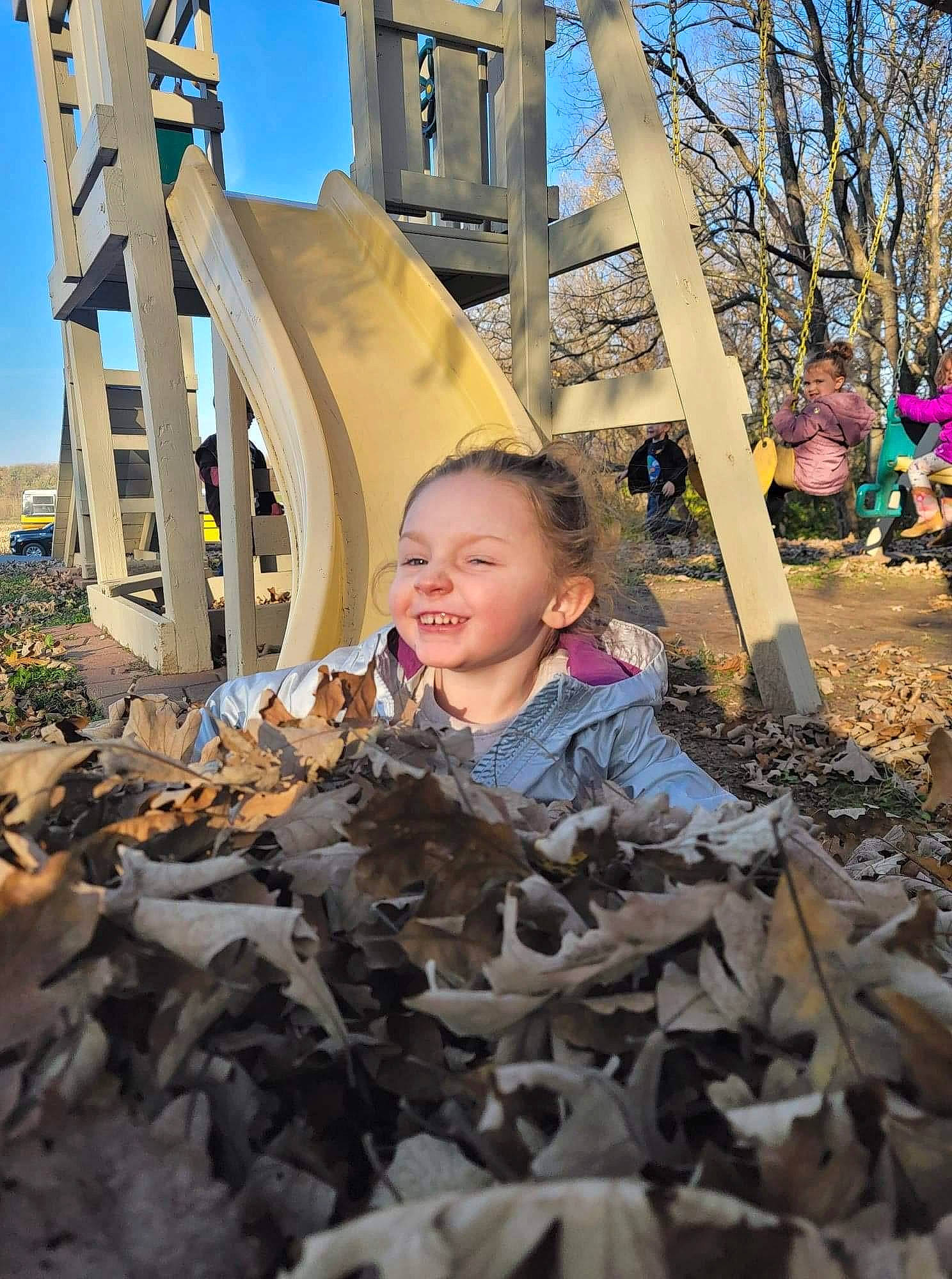 Rosalie is registered to the contest to win money with this photo: chute, city, daytime, deciduous, fun, grass, human_settlement, joy, leaf, leisure, metal, nature, person, plant, public_space, recreation, sky, smile, soil, tree