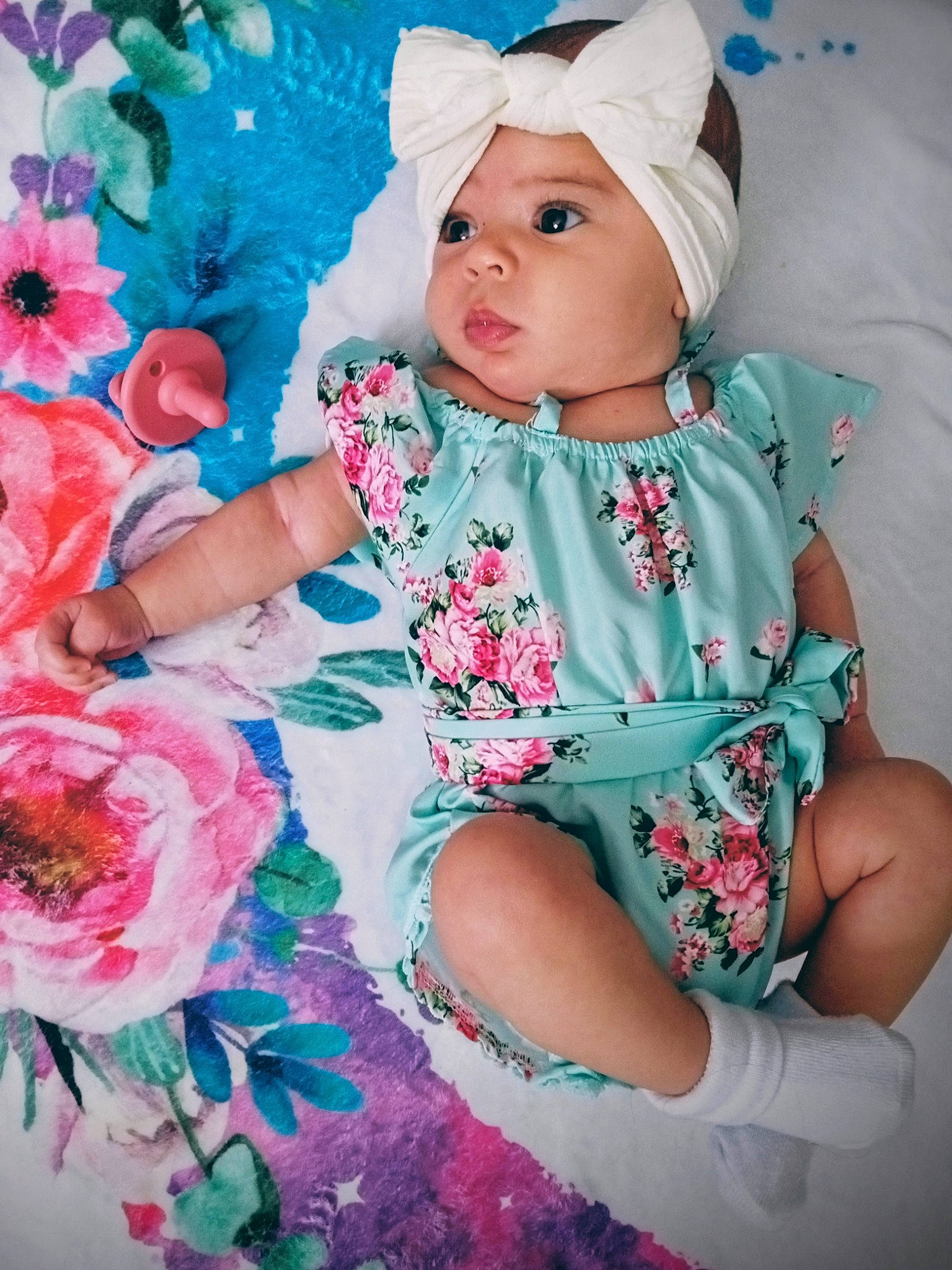 Amayah joined the competition — help win amazing prizes! baby, baby_toddler_clothing, child, day_dress, dress, embellishment, flower, grass, headwear, linens, magenta, pattern, peach, person, petal, pink, plant, sitting, sleeve, textile