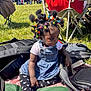 toddler, child, outdoor, sunny, grass, people, group, colorful_hair, hair_ties, denim_dress, tights, black_tights, heart_pattern, bag, blanket, sitting, park, event, serious_expression, daylight