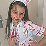 child, girl, costume, nurse, blood_splatter, face_paint, long_hair, indoor, door, hand_on_hip, posing, makeup, headband, white_outfit, red, young_person, expression, portrait, person, wall