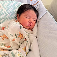 Riley joined the competition — help win amazing prizes! newborn, baby, sleeping, infant, portrait, hospital, bedding, blanket, floral_pattern, onesie, swaddled, peaceful, face, closed_eyes, dark_hair, indoors, bed, pillow, cozy, resting