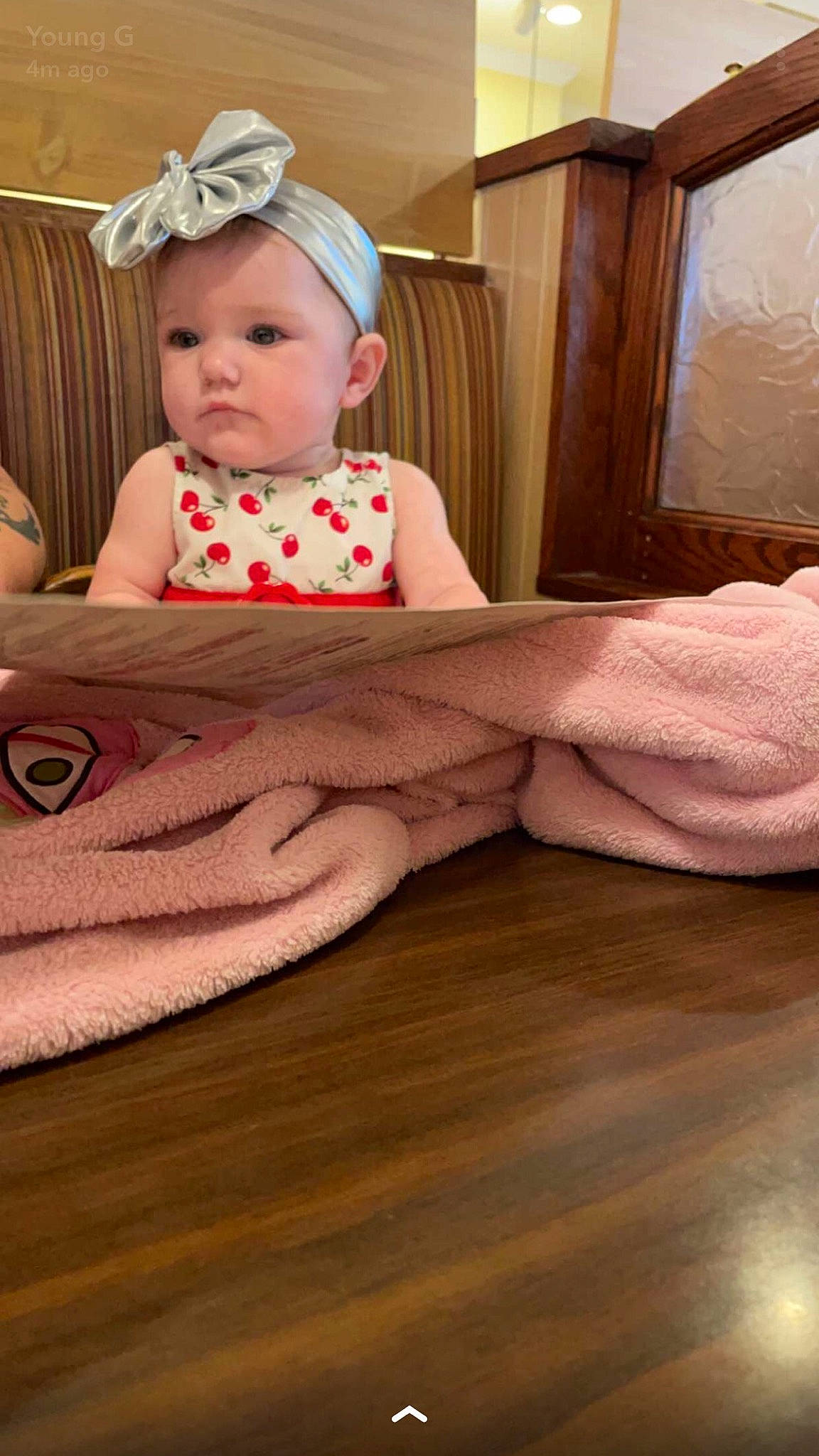 Melia is registered to the contest to win money with this photo: baby, baby_toddler_clothing, child, comfort, couch, floor, flooring, hardwood, hat, headband, headwear, human_leg, linens, pattern, person, sitting, skin, t_shirt, throw_pillow, toddler