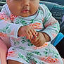 baby, infant, child, car_seat, floral_outfit, headband, hands, closeup, portrait, indoors, seatbelt, pink_socks, cute, expression, person, car_interior, window, light, skin, clothing