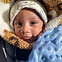 baby, child, face, hat, blanket, blue_blanket, jacket, fur_jacket, cozy, cute, infant, portrait, close_up, warm, sunlight, expression, smile, clothing, indoors, person