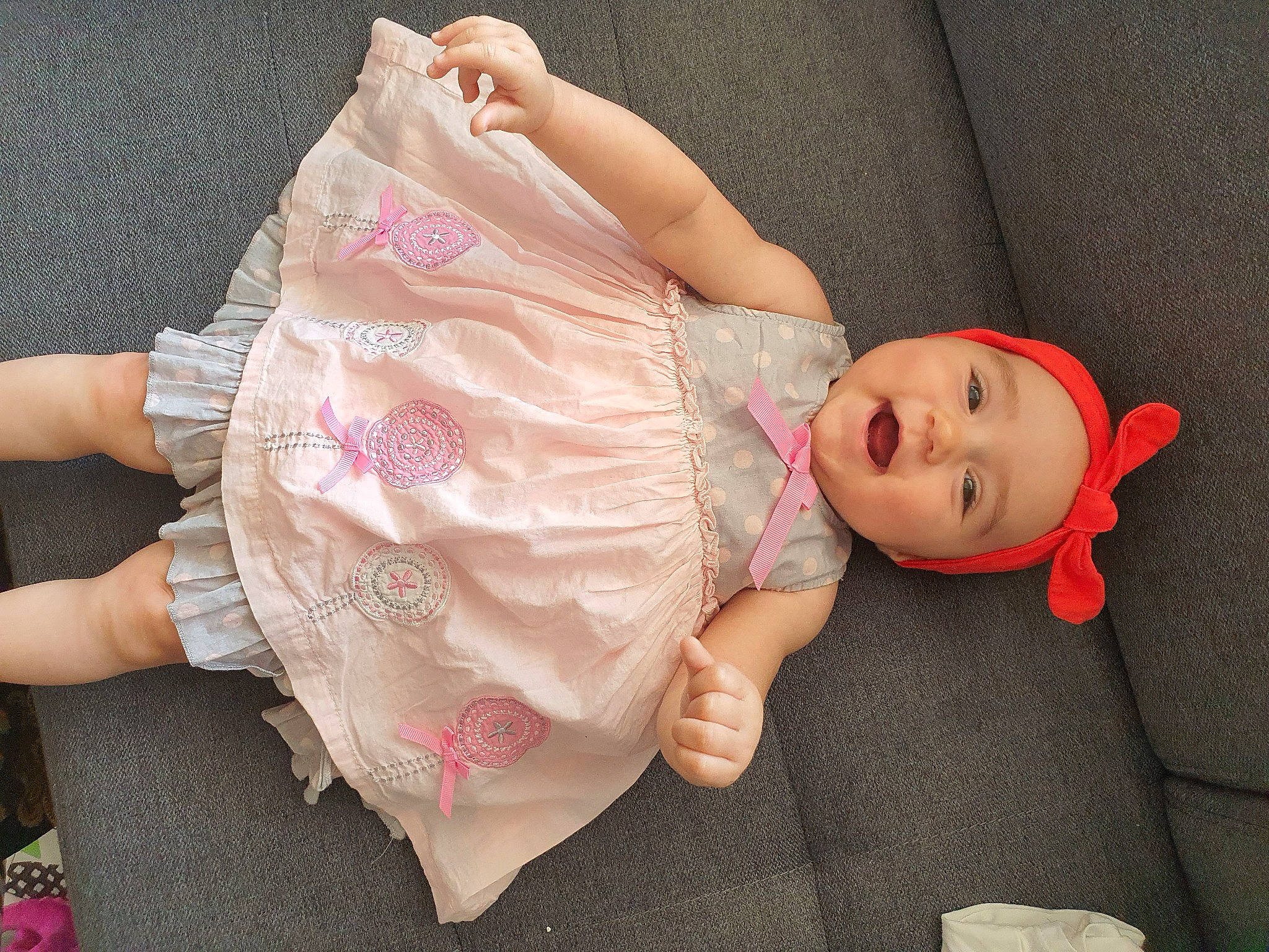 Anaëlle a rejoint le concours — aidez-le/la à gagner de superbes lots ! baby, baby_toddler_clothing, cheek, child, comfort, dress, finger, headgear, headwear, human_body, joint, lip, mouth, nail, person, pink, skin, sleeve, textile, thigh