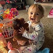 Jazalynn joined the competition — help win amazing prizes! toddler, child, plush_toy, carpet, pajamas, bottle, toy_basket, indoor, smiling, happy, floor, blanket, pink_toy, brown_toy, furniture, chair, table, home, person, playtime