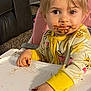 toddler, child, high_chair, messy, chocolate, food, face, hand, yellow_clothing, onesie, bee_pattern, indoor, carpet, furniture, pink_chair, curious, cute, baby, portrait, eating