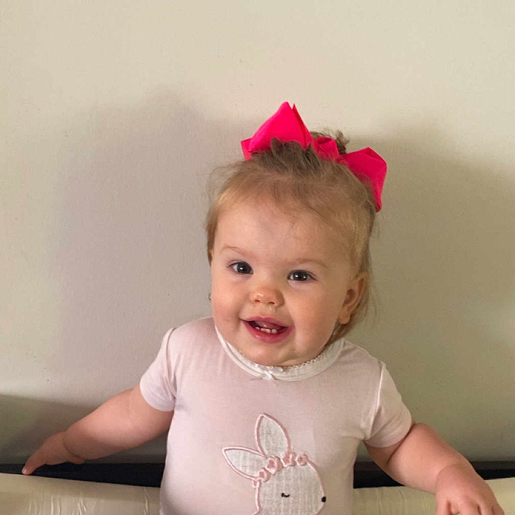 Sophie joined the competition — help win amazing prizes! architecture, baby, bodypart, building, clothing, couch, cushion, face, finger, furniture, hand, head, homedecor, indoors, pants, person, photography, portrait, sitting, t_shirt