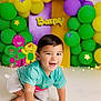 Mikel joined the competition — help win amazing prizes! toddler, child, smiling, crawling, balloons, purple_balloons, green_balloons, yellow_balloons, barney, background, decorations, playful, happy, indoor, cute, short_hair, casual_clothing, colorful, party, celebration
