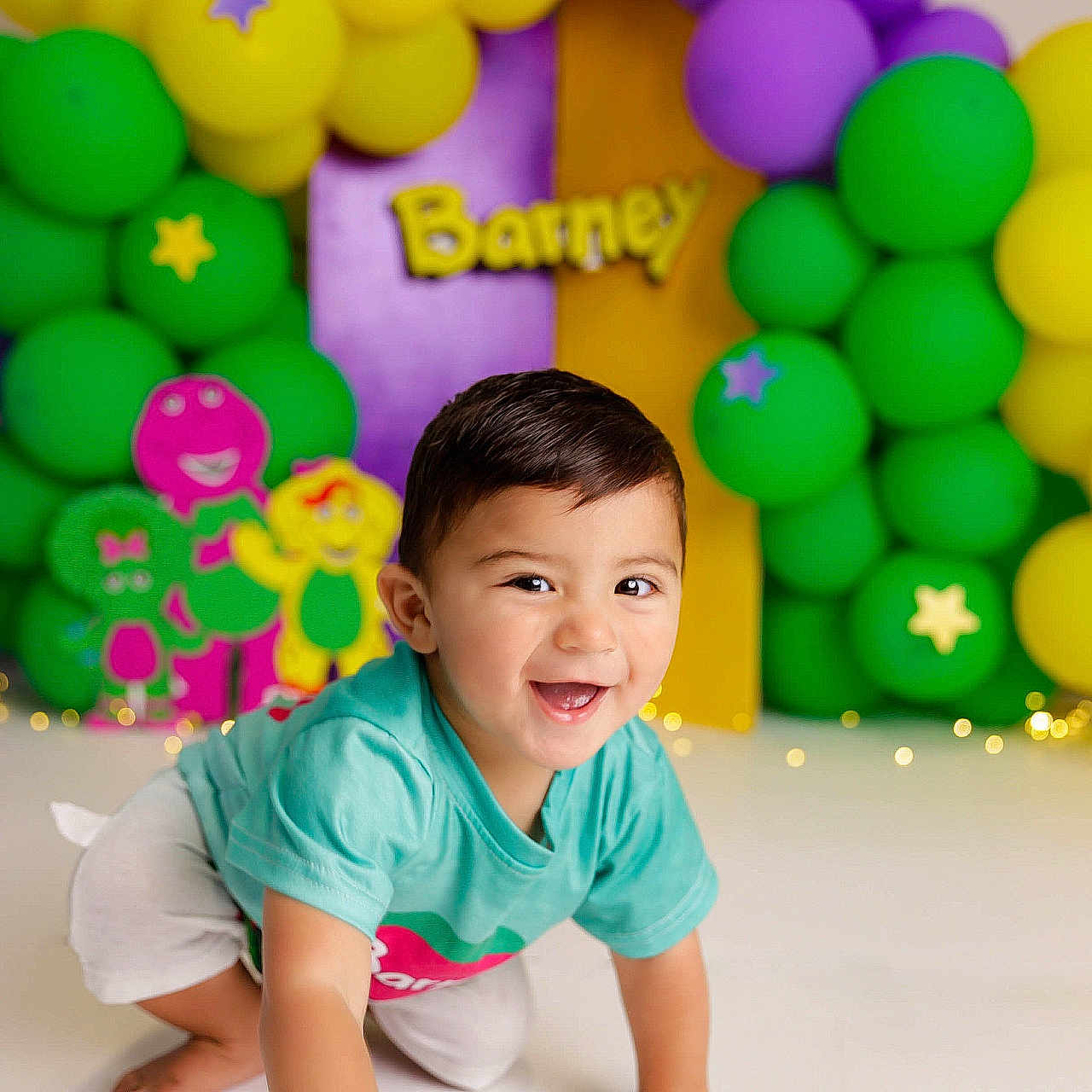 Mikel joined the competition — help win amazing prizes! background, balloons, barney, casual_clothing, celebration, child, colorful, crawling, cute, decorations, green_balloons, happy, indoor, party, playful, purple_balloons, short_hair, smiling, toddler, yellow_balloons